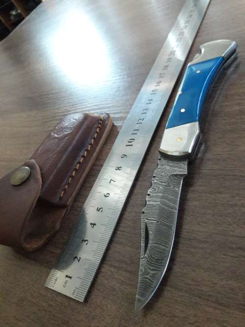 Handmade Damascus steel folding knife with Resin handle scales.