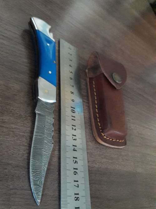Handmade Damascus steel folding knife with Resin handle scales.