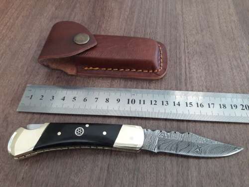 Handmade Damascus steel folding knife with Bull Horn handle scales.