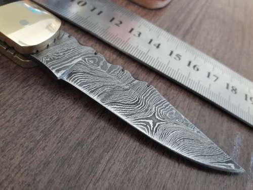 Handmade Damascus steel folding knife with Bull Horn handle scales.