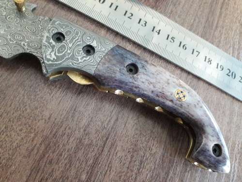 Handmade Damascus steel folding knife with Camel Bone handle scales.