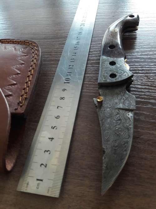 Handmade Damascus steel folding knife with Camel Bone handle scales.