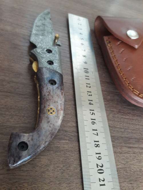 Handmade Damascus steel folding knife with Camel Bone handle scales.