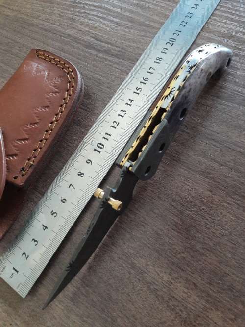 Handmade Damascus steel folding knife with Camel Bone handle scales.