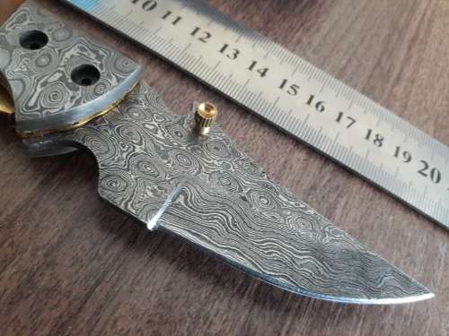 Handmade Damascus steel folding knife with Camel Bone handle scales.