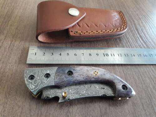 Handmade Damascus steel folding knife with Camel Bone handle scales.