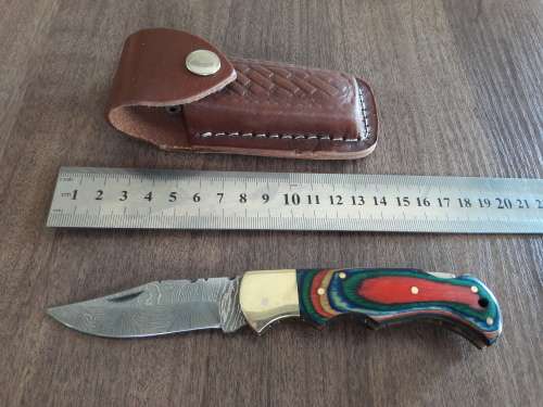 Handmade Damascus steel folding knife with Wooden handle scales.