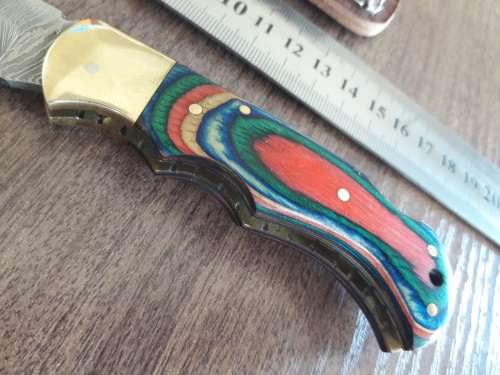 Handmade Damascus steel folding knife with Wooden handle scales.