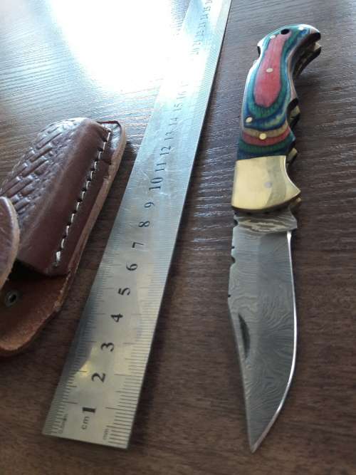 Handmade Damascus steel folding knife with Wooden handle scales.