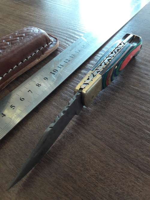 Handmade Damascus steel folding knife with Wooden handle scales.