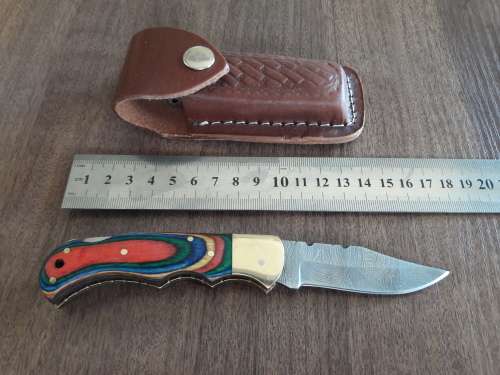 Handmade Damascus steel folding knife with Wooden handle scales.