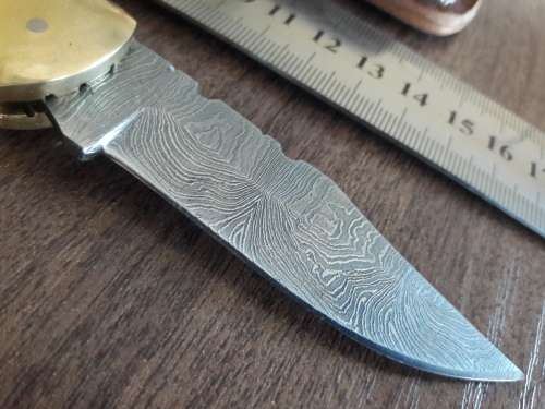 Handmade Damascus steel folding knife with Wooden handle scales.