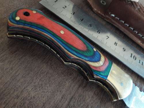 Handmade Damascus steel folding knife with Wooden handle scales.