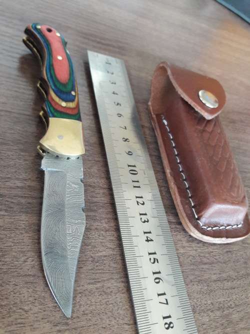 Handmade Damascus steel folding knife with Wooden handle scales.