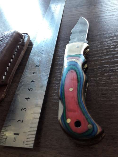 Handmade Damascus steel folding knife with Wooden handle scales.