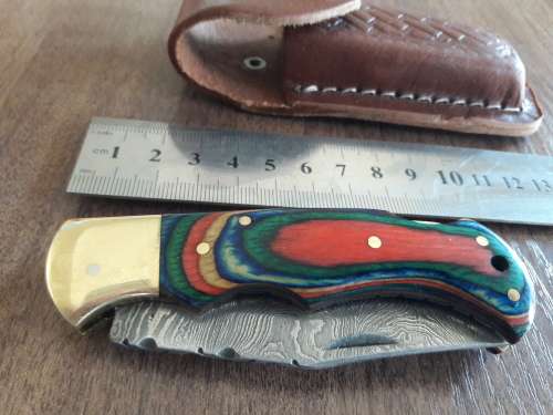 Handmade Damascus steel folding knife with Wooden handle scales.