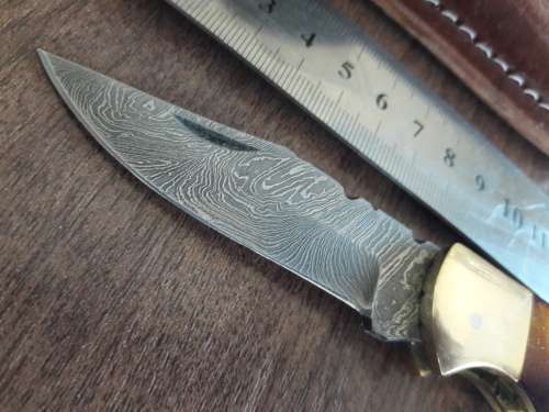 Handmade Damascus steel folding knife with Burnt Camel Bone handle scales.