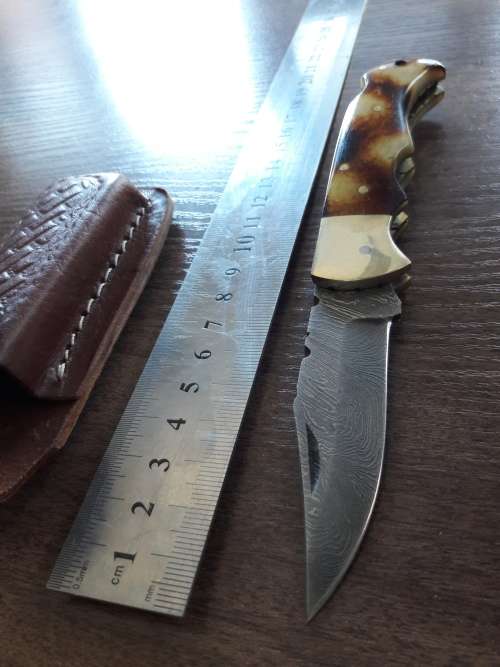 Handmade Damascus steel folding knife with Burnt Camel Bone handle scales.