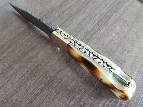 Handmade Damascus steel folding knife with Burnt Camel Bone handle scales.