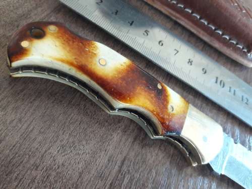 Handmade Damascus steel folding knife with Burnt Camel Bone handle scales.