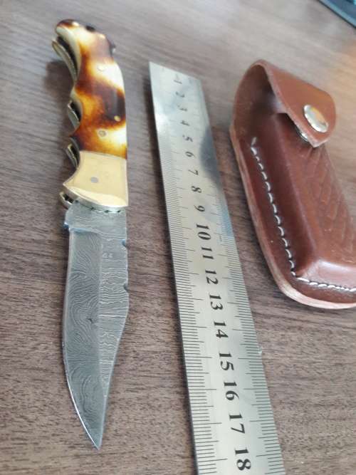 Handmade Damascus steel folding knife with Burnt Camel Bone handle scales.
