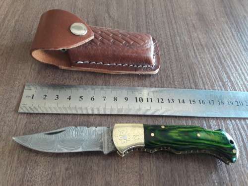 Handmade Damascus steel folding knife with Wooden handle scales.