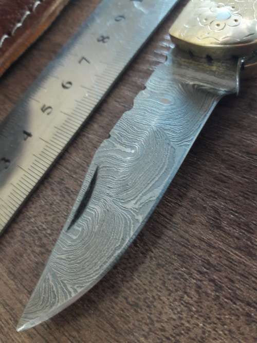 Handmade Damascus steel folding knife with Wooden handle scales.