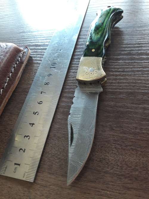 Handmade Damascus steel folding knife with Wooden handle scales.