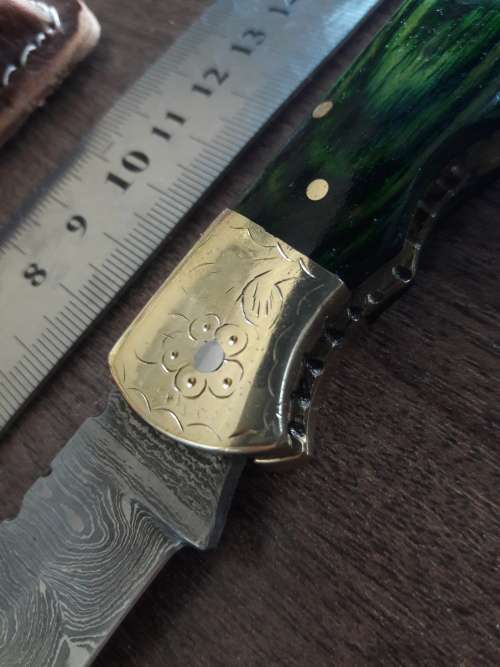 Handmade Damascus steel folding knife with Wooden handle scales.