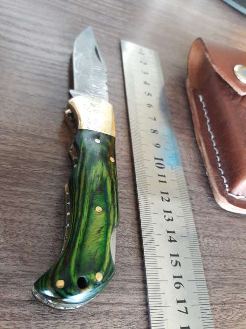 Handmade Damascus steel folding knife with Wooden handle scales.