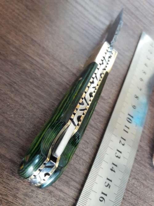 Handmade Damascus steel folding knife with Wooden handle scales.