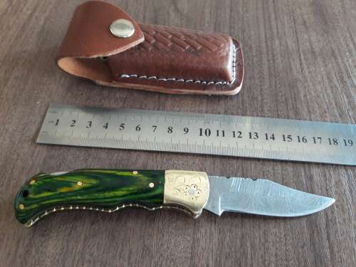Handmade Damascus steel folding knife with Wooden handle scales.