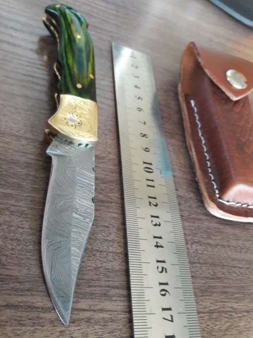 Handmade Damascus steel folding knife with Wooden handle scales.