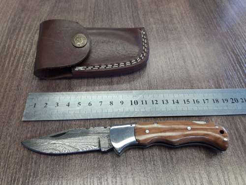 Handmade Damascus steel folding knife with Wooden handle scales.