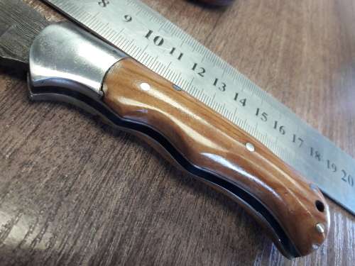 Handmade Damascus steel folding knife with Wooden handle scales.