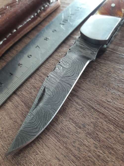 Handmade Damascus steel folding knife with Resin handle scales.