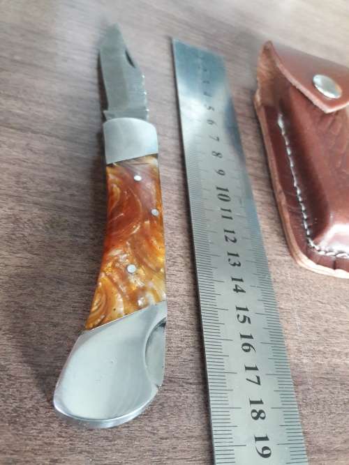 Handmade Damascus steel folding knife with Resin handle scales.