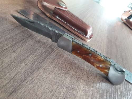 Handmade Damascus steel folding knife with Resin handle scales.