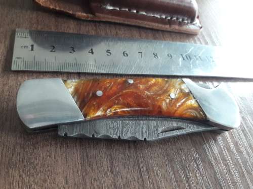 Handmade Damascus steel folding knife with Resin handle scales.