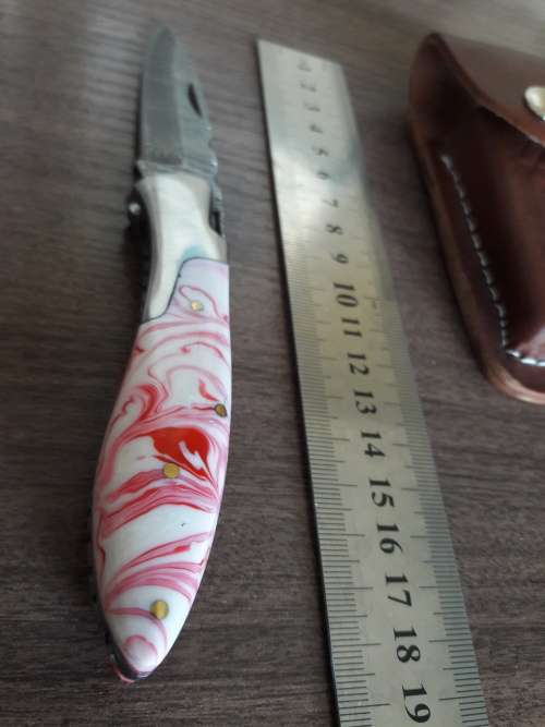 Handmade Damascus steel folding knife with Resin handle scales.
