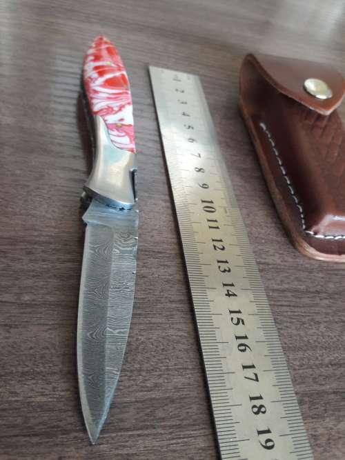 Handmade Damascus steel folding knife with Resin handle scales.