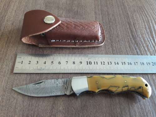 Handmade Damascus steel folding knife with Resin handle scales.