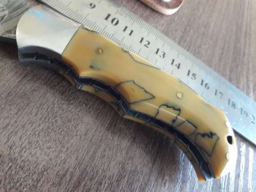 Handmade Damascus steel folding knife with Resin handle scales.