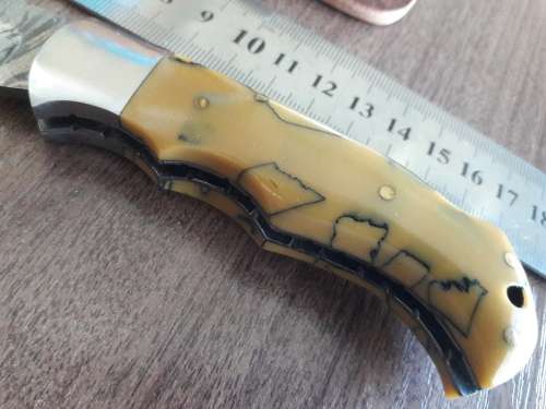 Handmade Damascus steel folding knife with Resin handle scales.