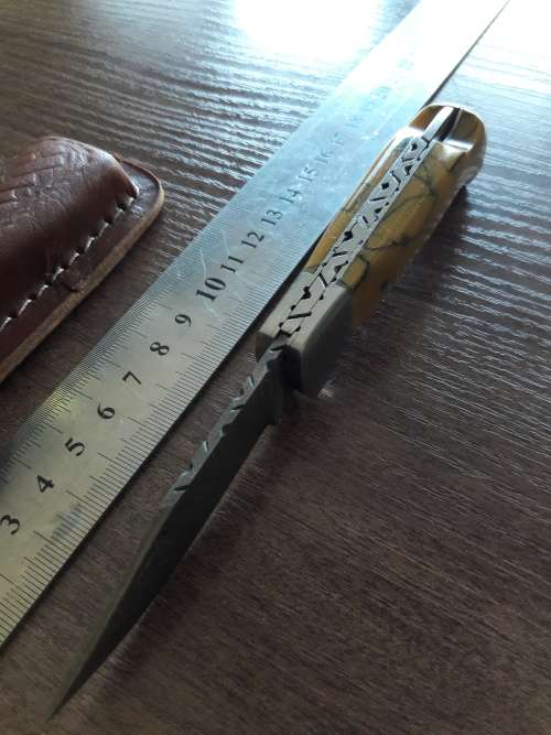 Handmade Damascus steel folding knife with Resin handle scales.