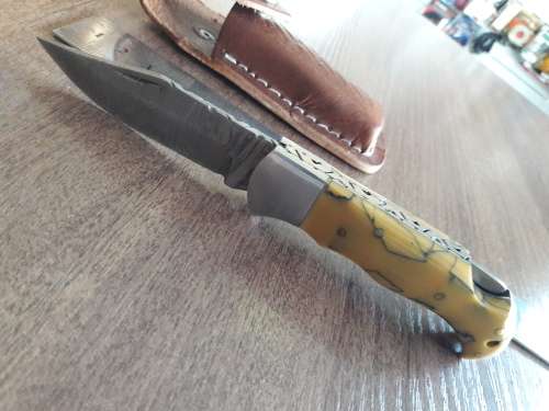 Handmade Damascus steel folding knife with Resin handle scales.