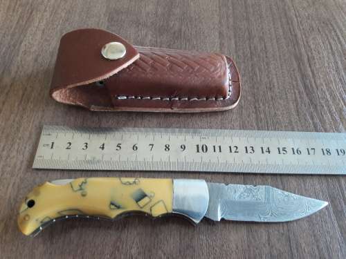 Handmade Damascus steel folding knife with Resin handle scales.