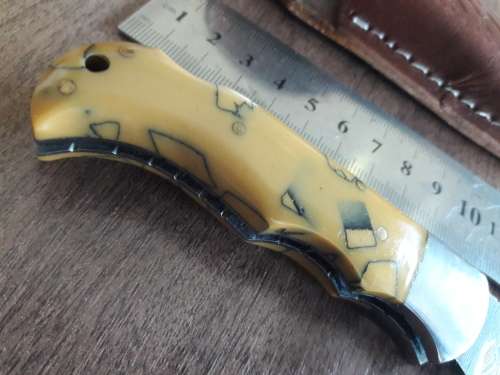 Handmade Damascus steel folding knife with Resin handle scales.