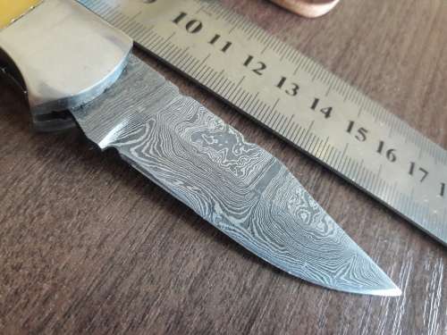 Handmade Damascus steel folding knife with Resin handle scales.