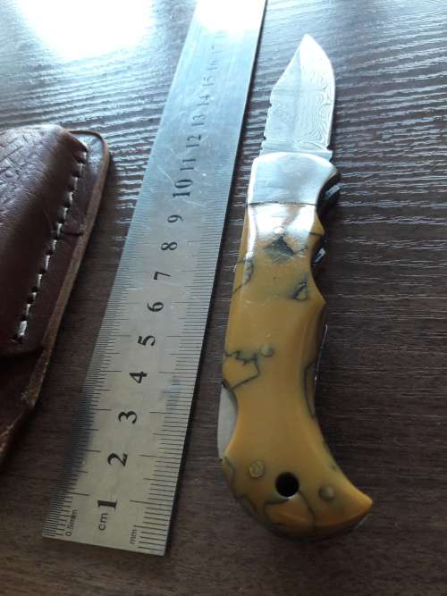 Handmade Damascus steel folding knife with Resin handle scales.